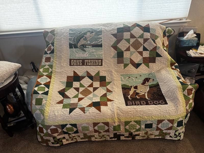 Gone Fishing Bird Dog quilt draped over armchair