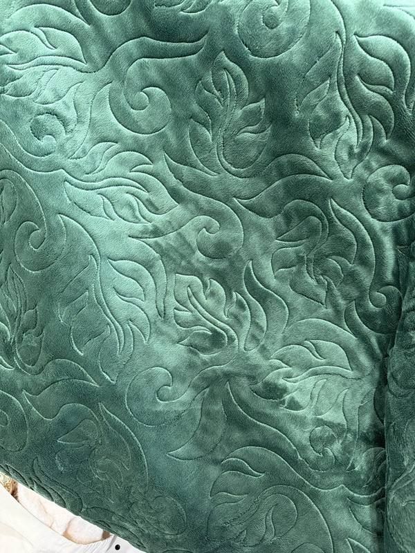 Sculpted scrollwork stitching on teal minky